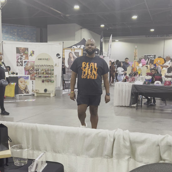 Black Real Men Go Bald t-shirt with orange text